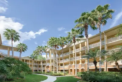 an exterior view of a resort with palm trees at Wyndham Cypress Palms 2BR Apartment with Resort Access in Kissimmee
