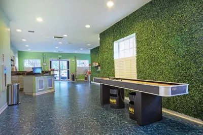 a pool table in a room with a green wall at Wyndham Cypress Palms 2BR Apartment with Resort Access in Kissimmee