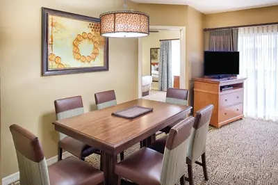 a dining room with a wooden table and chairs at Wyndham Cypress Palms 2BR Apartment with Resort Access in Kissimmee