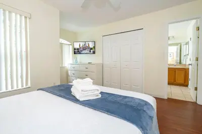 a bedroom with a bed with towels on it at Amazing 6 bedrooms with pool in Kissimmee