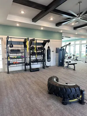 a gym with a tire in the middle of a room at Modern Oasis with King Bed, Fireworks View, 10 Minutes to Disney in Orlando
