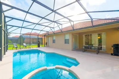 a swimming pool with a glass roof on a patio at Family Nest 4-Bedroom Home Near Disney World in Kissimmee