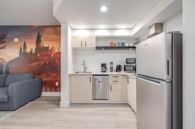 a kitchen with a refrigerator and a couch in a room at Harry Potter Suite near Epic & Universal in Orlando