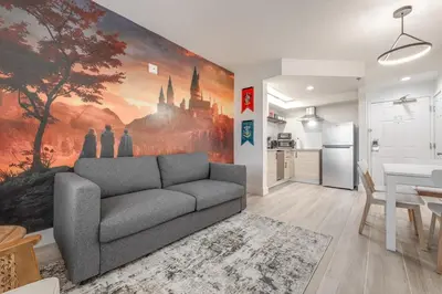 a living room with a couch and a kitchen at Harry Potter Suite near Epic & Universal in Orlando