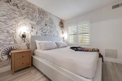 a bedroom with a large bed and a wall with graffiti at Harry Potter Suite near Epic & Universal in Orlando