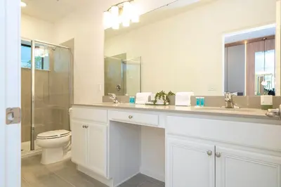 a white bathroom with a toilet and a sink at Paradiso Grande 6 bedroom New Home - 10377 in Orlando