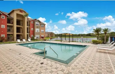 a swimming pool in a apartment complex at Adventure's at Villa Del Sol in Kissimmee