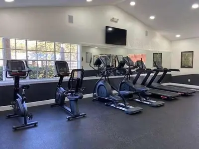 a gym with a bunch of exercise bikes in a room at Adventure's at Villa Del Sol in Kissimmee