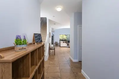 a hallway of a home with a counter with purple flowers at Adventurers Oasis - Private pool in Kissimmee