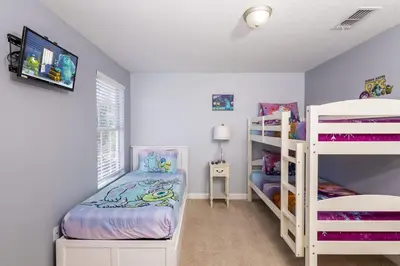 a bedroom with two bunk beds and a bed at Adventurers Oasis - Private pool in Kissimmee
