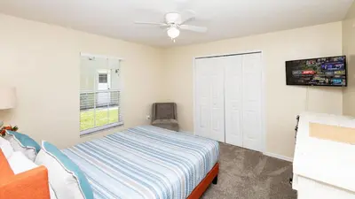 a bedroom with a bed and a ceiling fan at Beachy Retreat in Orlando