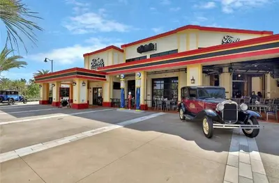 an old car parked in front of a store at Capri Sunset in Orlando