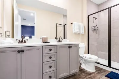 a bathroom with a sink and a toilet and a shower at Caribbean Dreamin - Vibrant Margaritaville Resort in Orlando