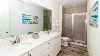 a bathroom with two sinks and a shower at Caribbean Summer - Serene Patio in Orlando