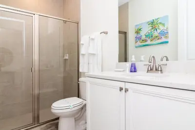 a bathroom with a shower and a toilet and a sink at Caribbean Summer - Serene Patio in Orlando