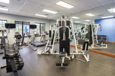 a gym with several tread machines and treadles at Casa de Kissimmee Sleeps up to 13 Guests in Kissimmee
