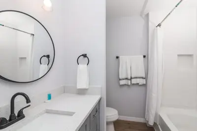 a white bathroom with a sink and a mirror at Celebrate at Club Cortile in Kissimmee