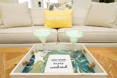 a coffee table with two wine glasses on top of it at Coconut Cabana - Access 4 Most in Orlando