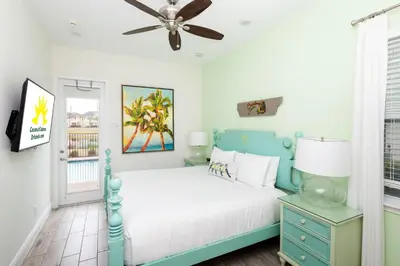 a bedroom with a bed and a ceiling fan at Coconut Cabana - Access 4 Most in Orlando