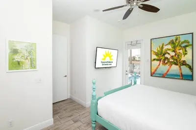 a bedroom with a bed and a ceiling fan at Coconut Cabana - Access 4 Most in Orlando