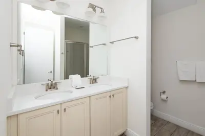 a bathroom with two sinks and a large mirror at Coconut Cabana - Access 4 Most in Orlando