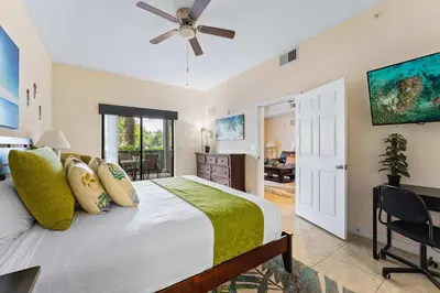 a bedroom with a bed and a ceiling fan at Cozy Cove - Caribe Escape for 8 in Orlando