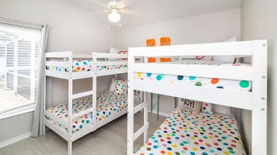 two white bunk beds in a room with a ceiling at Cozy on Cavendish - Themed bedrooms in Kissimmee