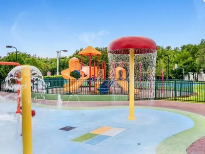 a water park with a playground with a water slide at Enchanted At 7 Dwarfs Lane in Kissimmee