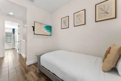 a bedroom with a bed and three pictures on the wall at Flamingo Paradise in Orlando
