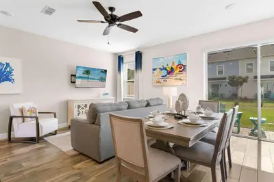 a living room with a table and a couch at Flamingo Paradise in Orlando