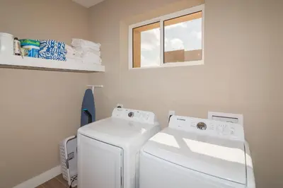 a laundry room with a washer and dryer and a window at Villa at Magic Village Resort with Outdoor Oasis in Orlando