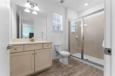a bathroom with a toilet and a sink and a shower at Frankly Fintastic - Happy Days in Orlando