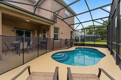 a swimming pool in the middle of a house at Veranda Sunshine Escape - 5 BDR in Kissimmee