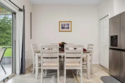 a kitchen and dining room with a table and chairs at Veranda Sunshine Escape - 5 BDR in Kissimmee