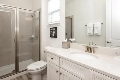 a bathroom with a toilet and a sink and a shower at Up to Scale With Margaritas in Orlando