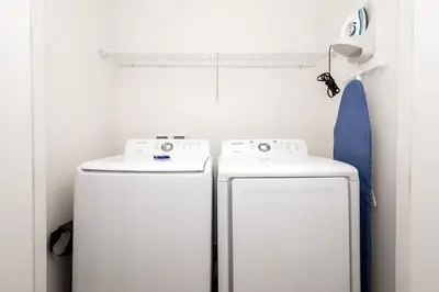 two white refrigerators in a white room with a shelf at Up to Scale With Margaritas in Orlando