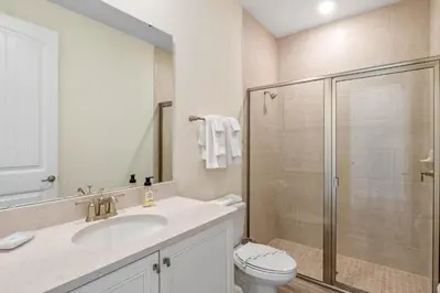 a bathroom with a shower and a sink and a toilet at Turquoise Breeze - Close to Disney in Orlando