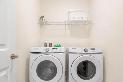 a laundry room with a washer and dryer at Turquoise Breeze - Close to Disney in Orlando