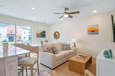 a living room with a couch and a table at Turquoise Breeze - Close to Disney in Orlando