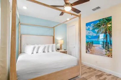 a bedroom with a bed and a ceiling fan at Turquoise Breeze - Close to Disney in Orlando