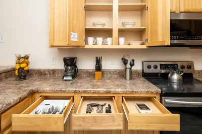 a kitchen with wooden cabinets and a counter top at Tranquil Breeze at Caribe Cove in Orlando