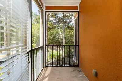 a balcony with a view of a tree at Tranquil Breeze at Caribe Cove in Orlando