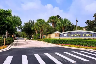 an empty street in front of a caribe cove sign at Tranquil Breeze at Caribe Cove in Orlando