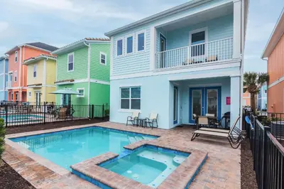 a swimming pool in front of a house at Trade Winds Life - Margaritaville in Orlando