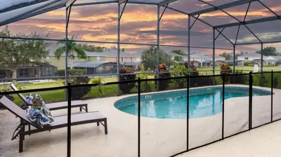 a view of a swimming pool from the balcony of a house at Jewel of Emerald Island with Heated Pool in Kissimmee