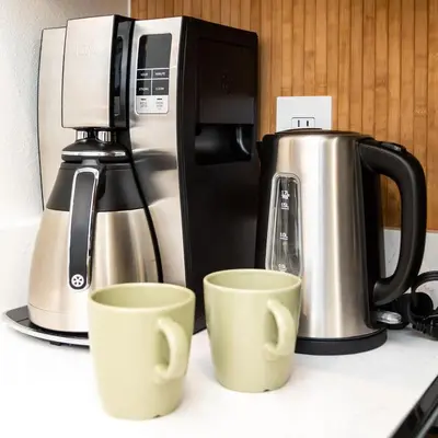 two coffee cups on a counter next to a coffee maker at Jewel of Emerald Island with Heated Pool in Kissimmee