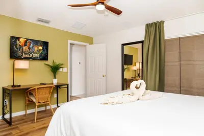 a bedroom with a bed with a ceiling fan at Jewel of Emerald Island with Heated Pool in Kissimmee