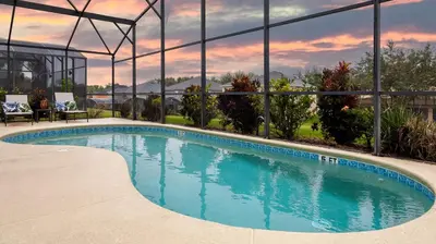 a swimming pool with a view of a building at Jewel of Emerald Island with Heated Pool in Kissimmee