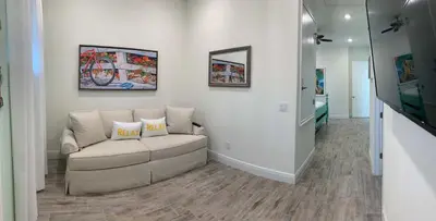 a living room with a couch and a flat screen tv at Krows Nest - Near Disney World & Universal in Orlando
