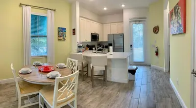 a kitchen and dining room with a table and chairs at Krows Nest - Near Disney World & Universal in Orlando